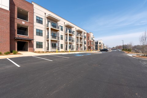 A parking lot in front of apartment buildings.
